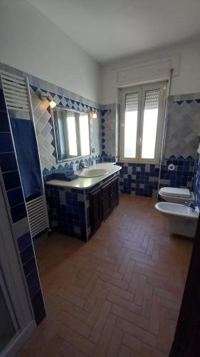 a large bathroom with a tub and a sink at Bed and Breakfast Dorgali in Dorgali