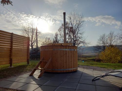 a wooden barrel sitting on a sidewalk next to a fence at The House of Dunja in Rakovica