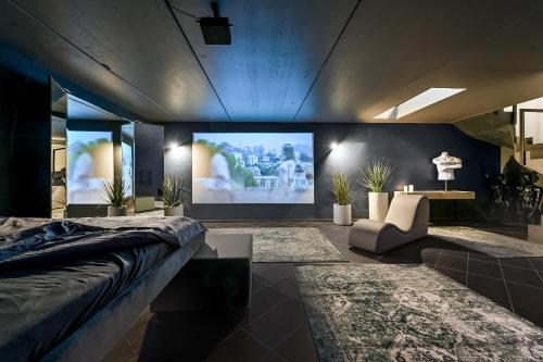 a bedroom with a large screen in the wall at Jacuzzi Cinema loft in Kaunas