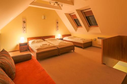 a large room with two beds and a couch at Wellness Apartmány Fatrapark 1 Malinô Brdo in Ružomberok