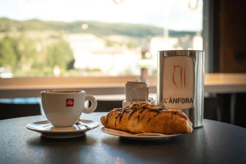 a pastry and a cup of coffee on a table at L'Anfora in Deruta