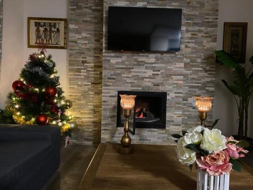 a living room with a christmas tree and a fireplace at Duplex de lujo en la playa , jacuzzy, piscina, chimenea y padel in Benalmádena