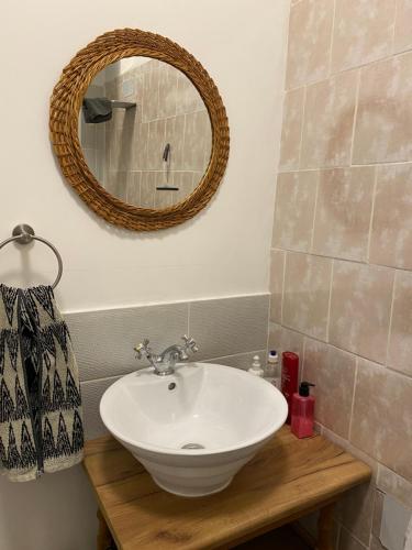 a bathroom with a sink and a mirror on the wall at Pērles in Līgatne