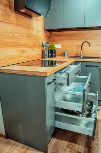 a kitchen with a sink and a counter top at Loftowy Zakątek in Leszno