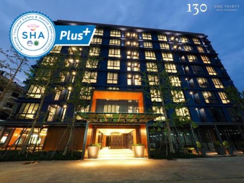 a building with a sign on the front of it at 130 Hotel & Residence Bangkok in Bangkok