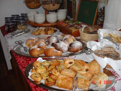 a table filled with lots of different types of pastries at Hotel Columbia & Spa in Cortina dʼAmpezzo