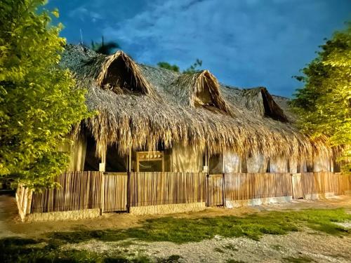 an old hut with a thatched roof at Mistica Island Hostel - Isla Palma in Isla Palma