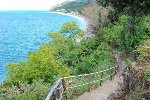 a path on a hill next to a body of water at Kastra in Velika