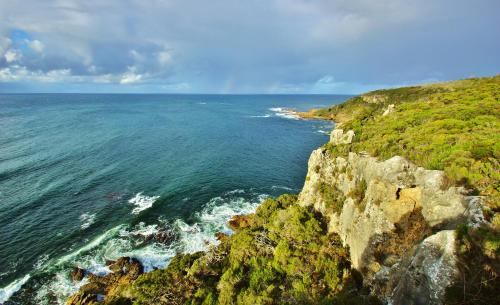 an aerial view of the ocean and a rocky coastline at Hideaway By the Bay in Busselton