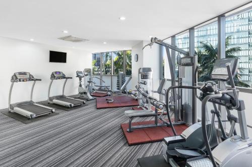 a fitness room with treadmills and cardio machines at Meriton Suites Herschel Street, Brisbane in Brisbane