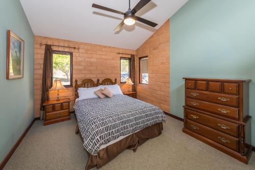 a bedroom with a bed and a ceiling fan at Clarendon Forest Retreat in Possum Brush