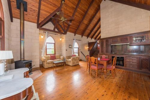 a large living room with a table and chairs at Clarendon Forest Retreat in Possum Brush