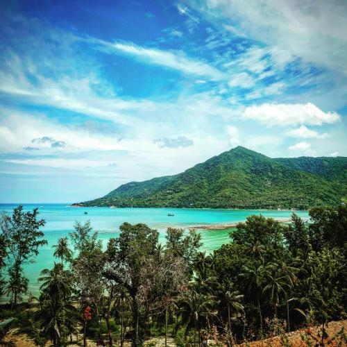 a view of a beach with trees and a mountain at Shiralea Backpackers Resort in Haad Yao