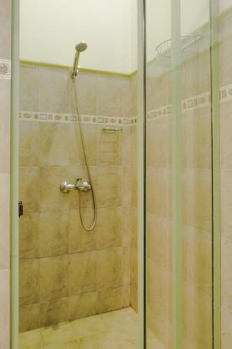 a shower with a glass door in a bathroom at Gruhaya Boutique Villa in Kandy