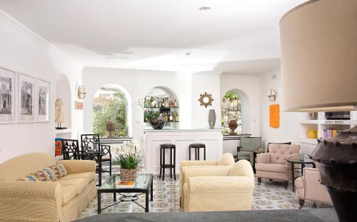 a living room filled with furniture and a fireplace at Hotel Canasta in Capri