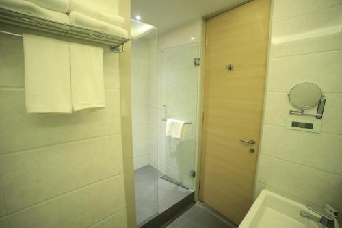 a bathroom with a shower and a sink at The Byke Delotel in Mumbai