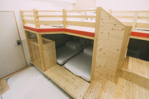 a wooden bunk bed in a room at 阿信輕旅 in Tainan