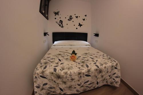 a bedroom with a bed with butterflies on the wall at FP HOTELs in Alcalá de Henares