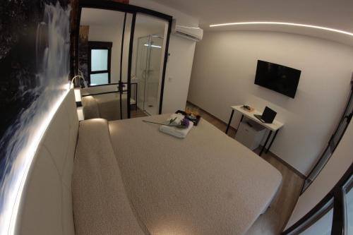 a small room with a table and a shower at FP HOTELs in Alcalá de Henares