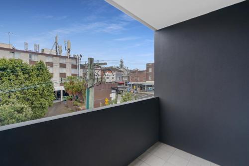 a balcony with a view of a city at Coogee Studio Apartments in Sydney