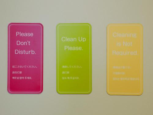 three different colored cell phones with the words cleaning is notrequired at Hotel the Lutheran in Osaka