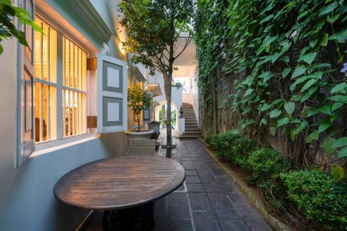 a wooden table sitting on a sidewalk next to a building at 55TG Boutique Suites in Colombo