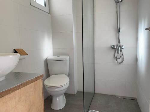 a bathroom with a toilet and a glass shower at Villa Chrissanthi Sea in Gouves