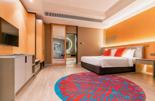 a bedroom with a bed and a red and blue rug at M World Hotel in Petaling Jaya