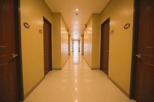 a corridor of a building with doors and a long hallway at Hotel 801 in Cagayan de Oro