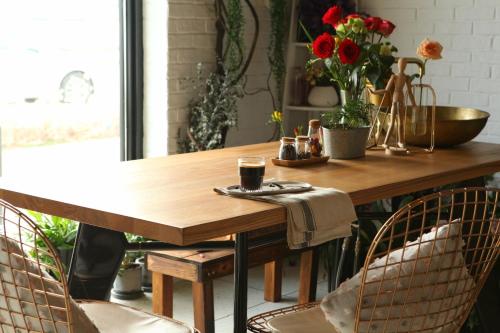 a wooden table with two chairs in a room at Cendre Hotel (Lingering Garden and Tiger Hill) in Suzhou
