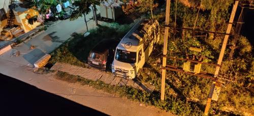 an overhead view of a bus parked next to a street at Akash homestay in Hampi