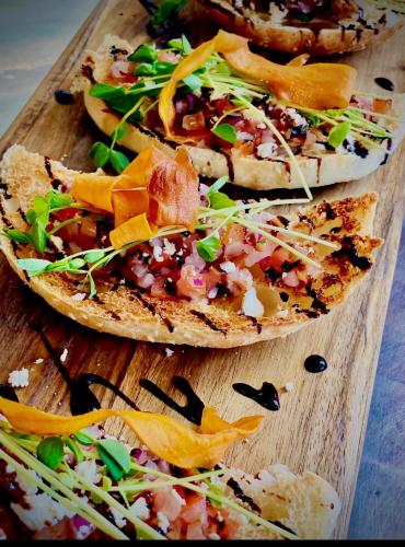 a group of pizzas on a wooden cutting board at Windsor Hotel Miles in Miles