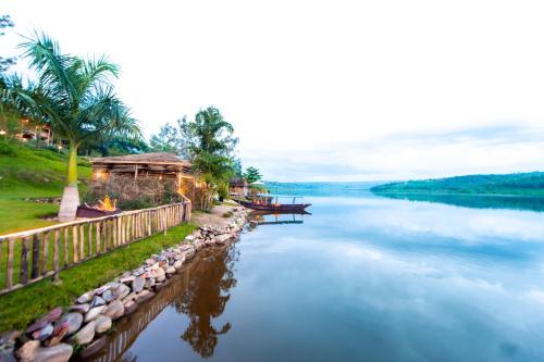 a view of a river with a house and palm trees at Vintage Cottage in Rwamagana