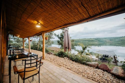 a patio with a view of a lake at Vintage Cottage in Rwamagana