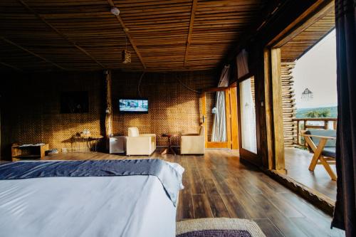 a bedroom with a bed and a television in a room at Vintage Cottage in Rwamagana