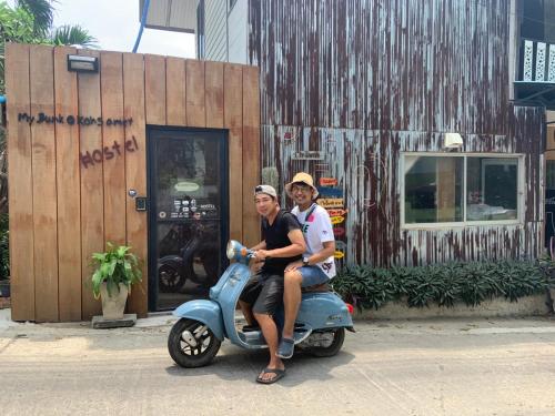 a man and a woman sitting on a scooter at My Bunk Hostel in Ko Samed