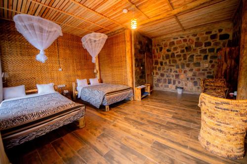 a bedroom with two beds in a room at Vintage Cottage in Rwamagana