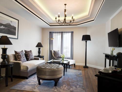 a living room with a couch and a table at Melia Purosani Yogyakarta in Yogyakarta