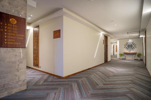 a corridor of a building with a wall at Coral Reef Hotel & Spa, Port Blair in Port Blair