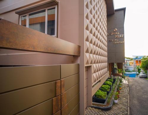 a view of the side of a building with plants at Coral Reef Hotel & Spa, Port Blair in Port Blair
