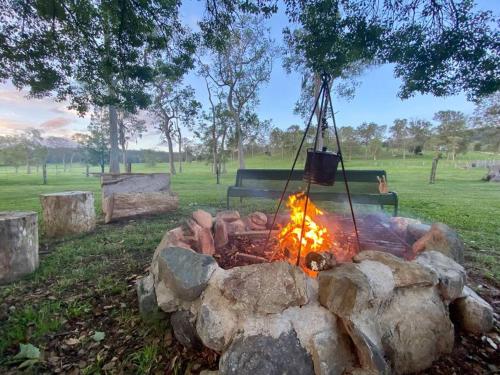 a fire pit with a pot hanging over it at Stay at the Barn... Immerse yourself in nature. in Kenilworth