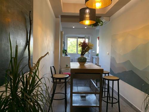 a dining room with a table and two stools at Stileroma in Rome