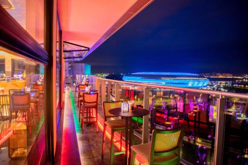 a bar with colorful chairs and a table on a balcony at Mumian Chengdu Dong'an Lake in Chengdu