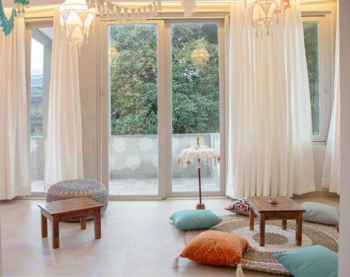 a living room with a large window and a table at Villa Ellena By The Villas 100 in Paragajen