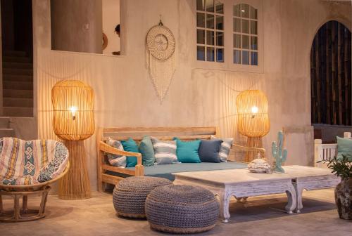 a living room with a couch and a table and chairs at Villa Ellena By The Villas 100 in Paragajen