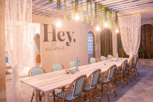 a long table in a room with chairs at Villa Ellena By The Villas 100 in Paragajen