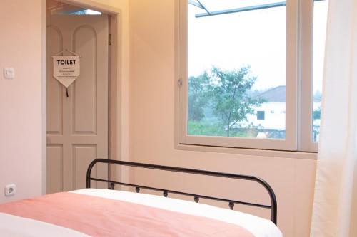 a bedroom with a bed and a window and a door at Villa Ellena By The Villas 100 in Paragajen