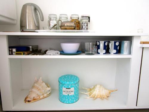 a kitchen shelf with shells and other items on it at Sherwood Garden in Cape Town