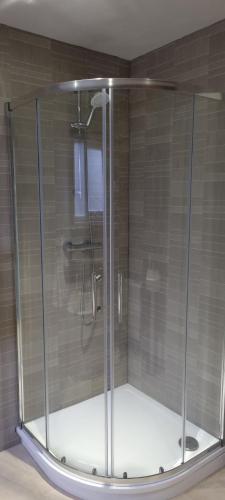 a shower with a glass enclosure in a bathroom at My Way Guest House in Durham