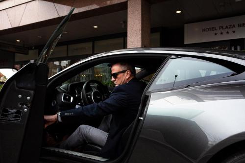 a man sitting in the drivers seat of a car at Mercure Biel in Biel